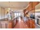 Well-equipped kitchen with a view of the living room featuring a cozy fireplace at 8537 E 35Th Ave, Denver, CO 80238