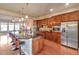 Spacious kitchen with stainless steel appliances, granite countertops, and an open view to the living room at 8537 E 35Th Ave, Denver, CO 80238
