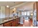 Modern kitchen flowing into living room with a view to a fireplace at 8537 E 35Th Ave, Denver, CO 80238