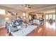 Open-concept living room with hardwood floors seamlessly connects to kitchen and dining areas at 8537 E 35Th Ave, Denver, CO 80238