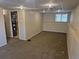 Finished basement with paneled walls, carpet, and window for natural light at 4678 S Lewiston Way, Aurora, CO 80015
