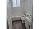 Updated bathroom featuring subway tile, tub, sink, and dark wood flooring at 4678 S Lewiston Way, Aurora, CO 80015