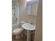This bathroom includes a pedestal sink, toilet, and a combined tub and shower at 4678 S Lewiston Way, Aurora, CO 80015