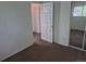 Bedroom with a sliding door closet, neutral carpet, and an open door at 4678 S Lewiston Way, Aurora, CO 80015