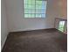 Bedroom with window bringing in natural light, neutral carpet, and electrical outlets at 4678 S Lewiston Way, Aurora, CO 80015