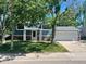 Ranch style home with blue siding, attached garage, and well-maintained lawn at 4678 S Lewiston Way, Aurora, CO 80015