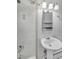 Bathroom with a white vanity sink and white tile shower, complete with chrome fixtures and a window at 505 Maple St, Golden, CO 80403