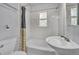 Charming bathroom with a tile shower and walls, a vanity sink, and a window for natural light at 505 Maple St, Golden, CO 80403