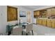 Cozy eat-in kitchen with vintage wood cabinets, neutral countertops, and natural lighting at 505 Maple St, Golden, CO 80403
