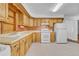 Bright kitchen with light wood cabinets, white appliances, and neutral countertops at 505 Maple St, Golden, CO 80403