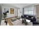 Bright, furnished living room with hardwood floors and large windows offering lots of natural light at 505 Maple St, Golden, CO 80403