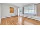 Bright, empty living room with hardwood floors and large windows offering lots of natural light at 505 Maple St, Golden, CO 80403
