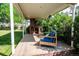 Covered patio with a brick fireplace and comfortable seating, ideal for relaxation at 505 Maple St, Golden, CO 80403