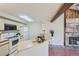 Well-lit kitchen with light-colored countertops and cabinets, with a view of the fireplace at 20 S Boulder Cir # 2303, Boulder, CO 80303