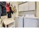 Functional laundry room with washer, dryer, and white cabinets for storage at 3751 W 136Th Ave # P3, Broomfield, CO 80023