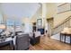 Bright living room featuring soaring ceilings, a cozy fireplace, and gleaming hardwood floors at 3751 W 136Th Ave # P3, Broomfield, CO 80023