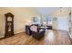 Inviting living room showcasing hardwood floors, large windows, and a traditional grandfather clock at 3751 W 136Th Ave # P3, Broomfield, CO 80023