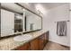 Bathroom with double sinks, granite countertops, and a tiled shower with glass door at 9300 E Florida Ave # 1101, Denver, CO 80247