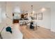 Open-concept dining area next to the kitchen, with a round table and stylish chairs at 9300 E Florida Ave # 1101, Denver, CO 80247