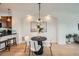 Bright dining room with modern light fixture, round table and contemporary decor at 9300 E Florida Ave # 1101, Denver, CO 80247