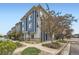 Street view of modern townhomes with blue and gray siding, showcasing the neighborhood's curb appeal at 9300 E Florida Ave # 1101, Denver, CO 80247