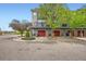 Exterior view of modern townhomes showcasing red garage doors and landscaping at 9300 E Florida Ave # 1101, Denver, CO 80247