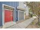 Modern townhome showcasing blue siding, a red door, and stone landscaping at 9300 E Florida Ave # 1101, Denver, CO 80247