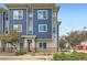 Modern townhome with blue and gray exterior, stone accents, and well-maintained landscaping at 9300 E Florida Ave # 1101, Denver, CO 80247