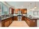 Stylish kitchen with stainless steel appliances, granite countertops, and warm wood cabinetry at 9300 E Florida Ave # 1101, Denver, CO 80247