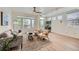 Sunlit living room featuring a ceiling fan, large windows, and contemporary decor at 9300 E Florida Ave # 1101, Denver, CO 80247