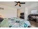 Spacious main bedroom with a large bed, ceiling fan, and a designated workspace at 9300 E Florida Ave # 1101, Denver, CO 80247