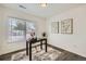 Bright home office with a desk, artwork, and natural light from a large window at 9300 E Florida Ave # 1101, Denver, CO 80247