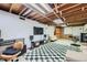 Spacious basement with rec area, tv, an exposed ceiling, and a checkered area rug at 7950 Maria St, Westminster, CO 80030