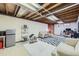 Finished basement area with a kitchenette, lounge area, and an exposed ceiling at 7950 Maria St, Westminster, CO 80030