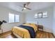 Cozy bedroom featuring a queen bed, wood floors, and modern ceiling fan at 7950 Maria St, Westminster, CO 80030