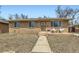 Quaint brick home with beautiful landscaping creates an inviting atmosphere at 7950 Maria St, Westminster, CO 80030