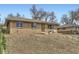 All-brick home with mature trees and landscaping creates an inviting curb appeal at 7950 Maria St, Westminster, CO 80030