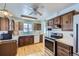 A bright kitchen with stainless steel appliances and wood cabinets for storage at 7950 Maria St, Westminster, CO 80030