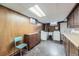 Functional laundry area with wood cabinets, utility sink, and laundry machines at 7950 Maria St, Westminster, CO 80030