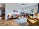 Bright living room with hardwood floors, a stylish sofa, and a decorative bookcase at 7950 Maria St, Westminster, CO 80030
