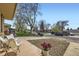 A lovely view of the street, framed by mature trees, from the front yard at 7950 Maria St, Westminster, CO 80030