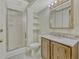 Bathroom featuring wood vanity, sink, and shower with sliding glass door and shelving at 2675 S Carson Way, Aurora, CO 80014
