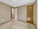 Bedroom with neutral walls and carpet; features two doors and modern lighting at 2675 S Carson Way, Aurora, CO 80014