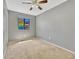 Bedroom with neutral carpet, gray walls, a ceiling fan, and window providing natural light at 2675 S Carson Way, Aurora, CO 80014