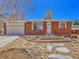 Charming brick home with a well-maintained front yard, inviting entrance, and attached two-car garage at 2675 S Carson Way, Aurora, CO 80014