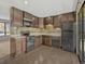 Well-equipped kitchen with sleek appliances, dark cabinets, and convenient access to the backyard at 2675 S Carson Way, Aurora, CO 80014