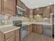 Modern kitchen featuring efficient layout, modern appliances, ample counter space, and stylish backsplash at 2675 S Carson Way, Aurora, CO 80014