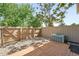 Fenced backyard with a wooden deck and decorative rock at 3300 W Florida Ave # 117, Denver, CO 80219