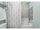 Stylish bathroom with tiled shower and decorative shower curtain at 3300 W Florida Ave # 117, Denver, CO 80219