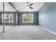 Large bedroom featuring neutral carpet, natural light, and mirrored closet at 3300 W Florida Ave # 117, Denver, CO 80219